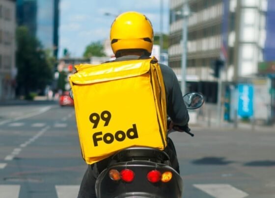 Motociclista com caixa de entrega da 99Food