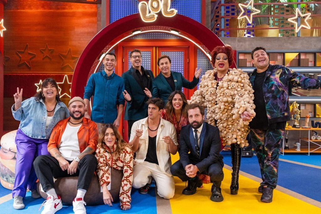 Elenco da 5ª temporada de LOL Brasil em frente ao cenário - Metrópoles